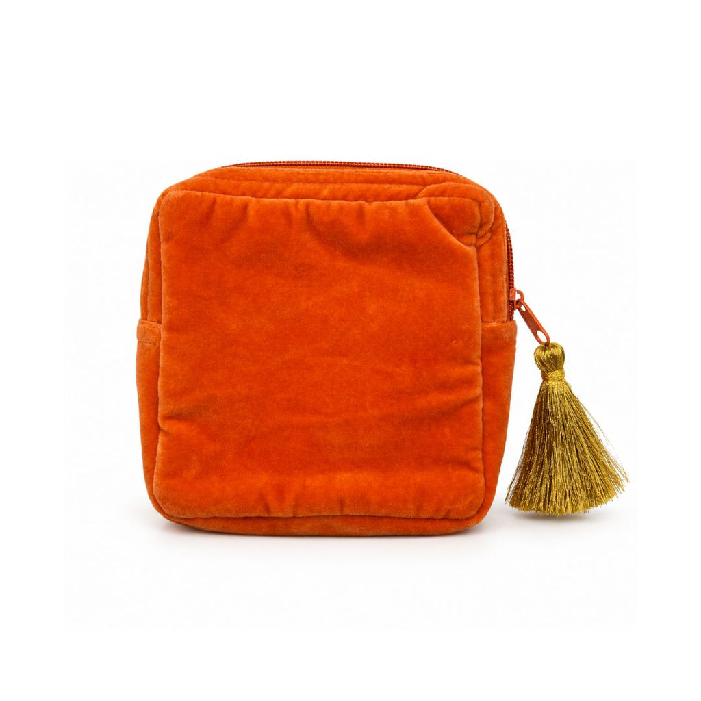 An orange velvet zippered pouch with a decorative gold tassel zipper pull, shown on a plain white background.